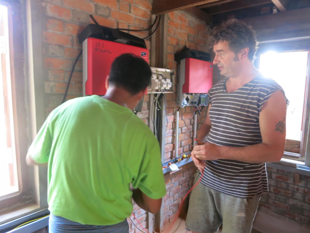 Kyaw Min Tun and Harald connecting the two SMA Sunny Boy panel inverters 